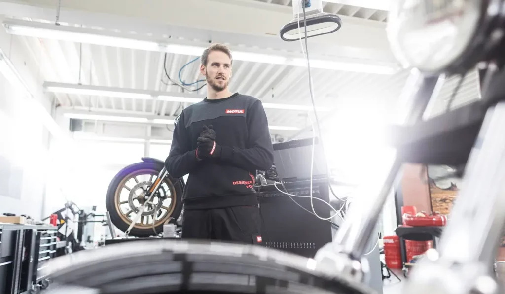 man in a bike shop preparing to work on bikes